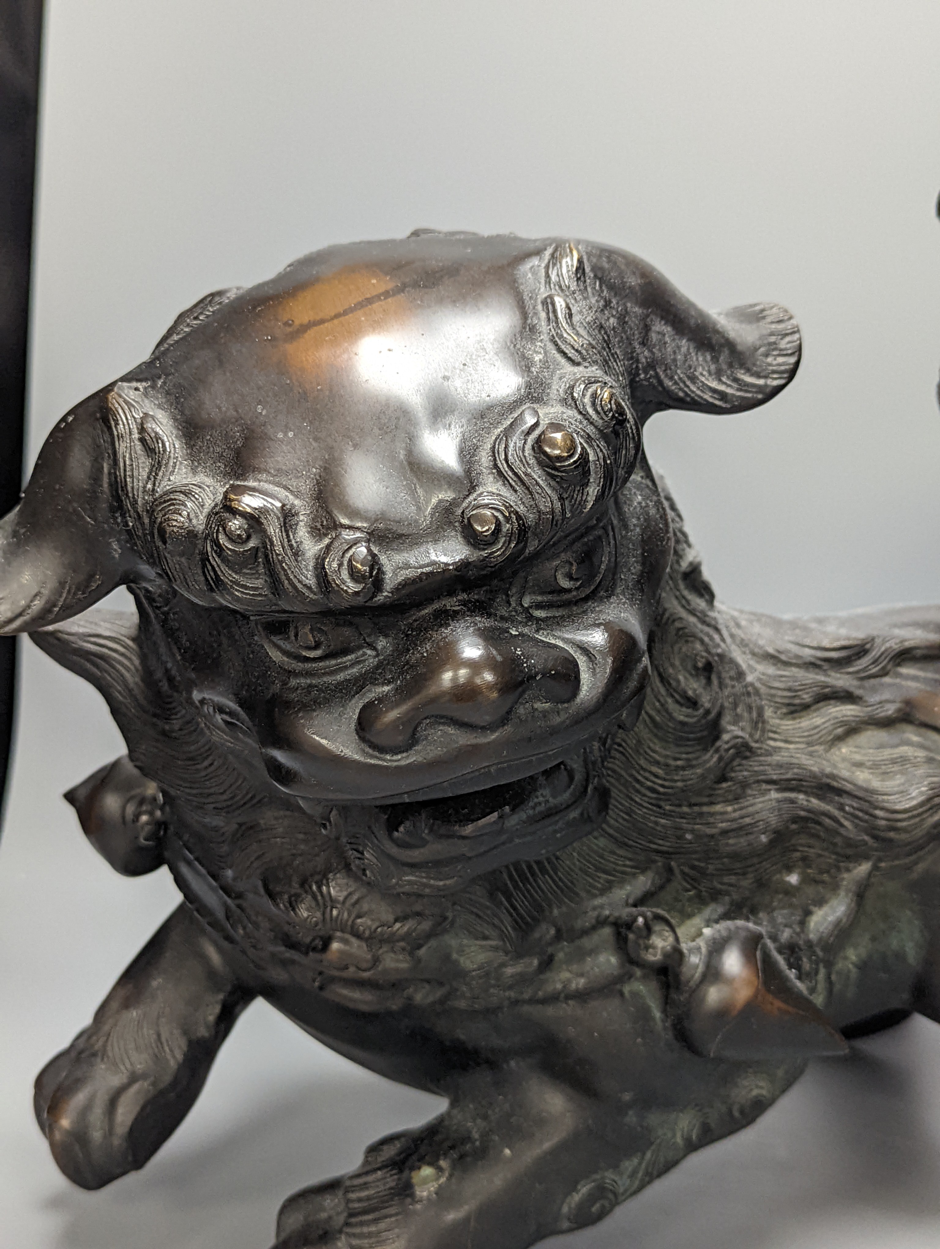 A large Chinese or Japanese bronze figure of a lion-dog or kara shi-shi, 45 cm long